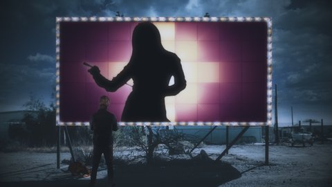 Watching Strip Tease Girl On Outdoor Billboard Panel at Night. Man outside looking to a silhouette of a girl dancing on a large billboard outdoor