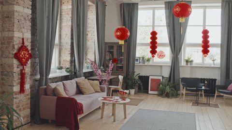 Tracking wide shot of interior of living room decorated for Chinese New Year