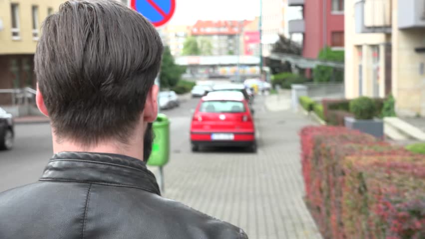 young handsome hipster man walking on the street - shot from back