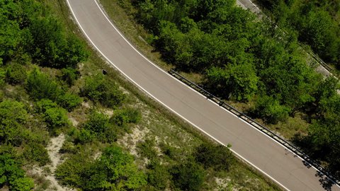 Aerial: Tourists Riding Bikes On Road During Vacation, Drone Flying Over Green Trees - Apennine Mountains, Italy
