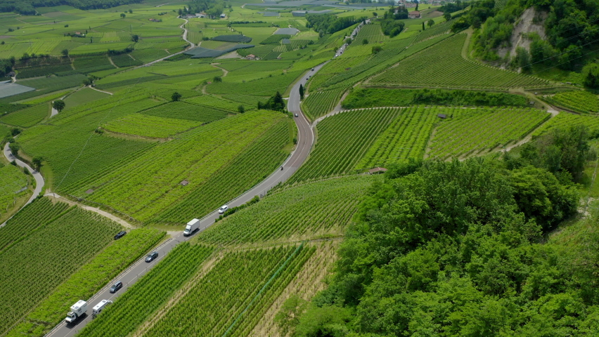 Aerial: Scenic View Of Cars Moving On Road Amidst Green Landscape During Sunny Day - Hintersee, Germany