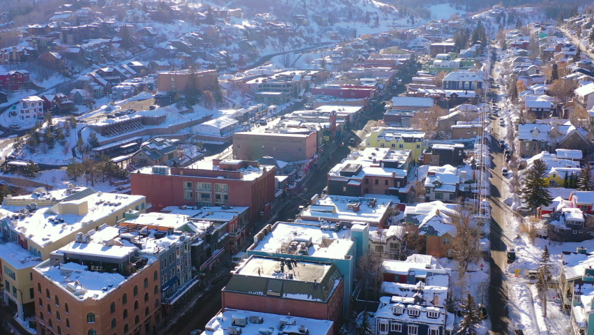 Aerial Slow Tilt Up Over A Residential Neighborhood In A Snowy Mountain Ski Town With Quiet Streets And Bright Morning Sunlight - Park City, Utah