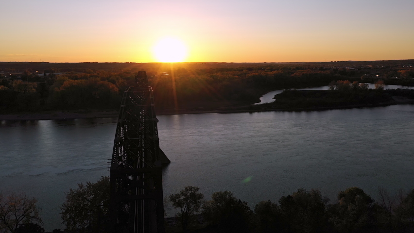 Aerial view of old railroad bridge spanning the Missouri River at sunset in Bismarck North Dakota.