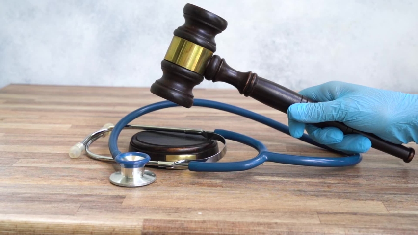 someones hand with law gavel in hand, medical law concept