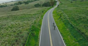 Aerial video of cyclists road biking on beautiful country road