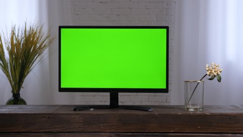 Smart tv monitor green screen. Contemporary living room tv green chroma key screen television set 2000s. Lcd tv home watching television. Flat screen television in bedroom interior