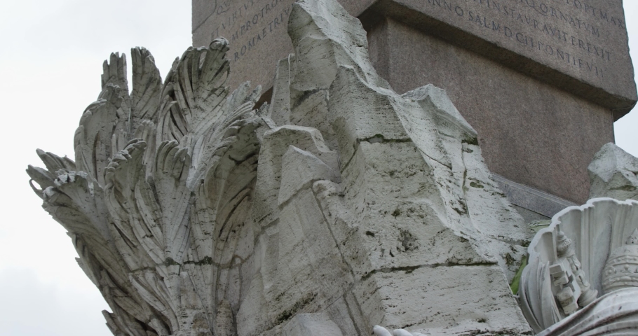Panning left shot: Fountain of the four rivers in Piazza Navona Rome Italy. Palm sculpture close-up. Slow motion 50fps 4k