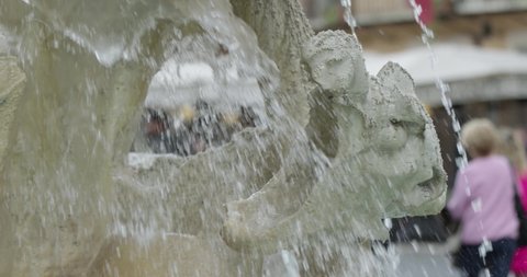 Panning left shot: Fountain of the four rivers in Piazza Navona Rome Italy. Dragon sculpture close-up with waterfall. Slow motion 50fps 4k