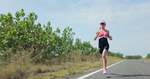 asian woman is running on road training for triathlon or healthy lifestyle