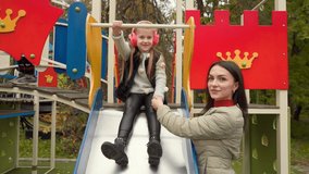 mom goes for a walk with her daughter to the playground and enjoys the time spent with her