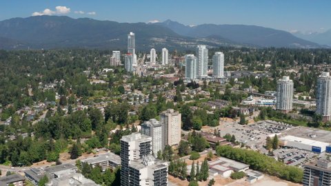 Burquitlam Transit Station And High-rise Apartment Complex In Coquitlam, BC, Canada. - aerial, wide