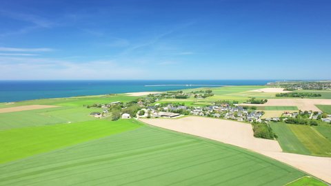 A village on the edge of the cliffs on the edge of the English Channel in Europe, France, Normandy, towards Deauville, in summer, on a sunny day.