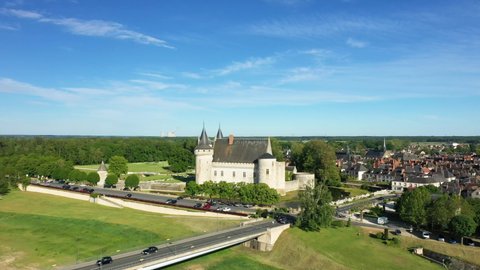 The castle of Sully sur Loire and the nuclear power station of Dampierre in Europe, in France, in the Center region, in the Loiret, in summer, on a sunny day.