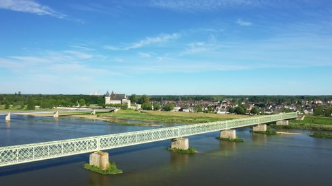 The town of Sully sur Loire, its castle and its nuclear power station in Europe, in France, in the Center region, in the Loiret, in summer, on a sunny day.