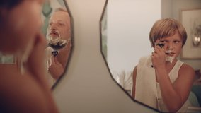 Father and son having fun shaving together. Quality time with kid in modern, boho bathroom - Powered by Shutterstock - Get 15% off with code: PIKWIZARD15
