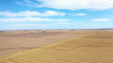AMERICA - CIRCA 2020s - Good aerial over vast flat farmland and fields in Iowa, Illinois, Kansas, Nebraska, or Indiana.