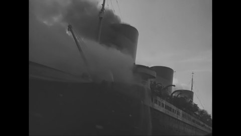 CIRCA 1930s - A docked, burning ship is engulfed in smoke.