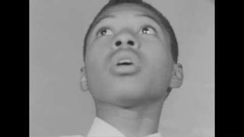 CIRCA 1963 - An African-American church choir rehearses, and a teenage boy in it gets bored practicing.