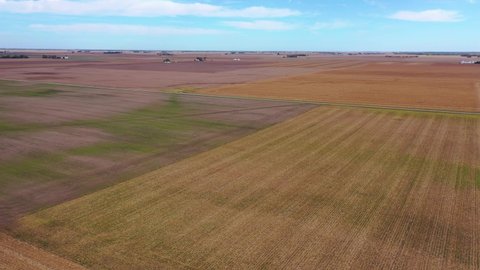 AMERICA - CIRCA 2020s - Good aerial over vast flat farmland and fields in Iowa, Illinois, Kansas, Nebraska, or Indiana.