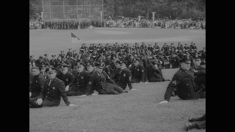 CIRCA 1937 - Graduates listen attentively to a speech by Mayor La Guardia at the New York Police Academy's commencement ceremony.