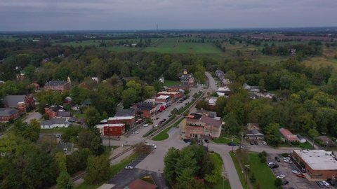 MIDWAY, KENTUCKY - CIRCA 2020s - Aerial establishing shot over main street small town USA with water tower, Midway, Kentucky.