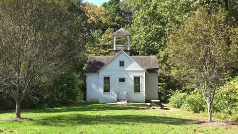 AMERICA - CIRCA 2020s - Establishing shot of a one room schoolhouse in the countryside.