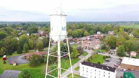 AMERICA - CIRCA 2020s - Aerial establishing shot over main street small town USA with water tower, Midway, Kentucky.