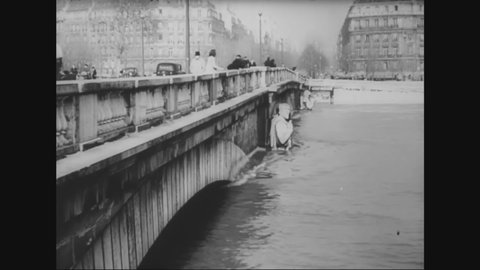 CIRCA 1945 - The Seine floods Paris, but civilians stay strong.