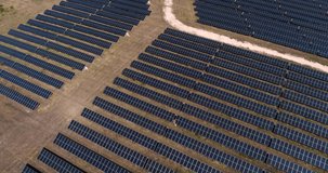 Aerial footage of photovoltaic solar farm. Solar farm power station from above. Ecological renewable energy.