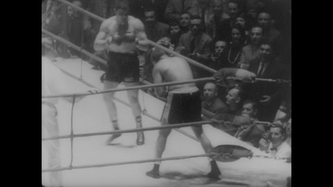 CIRCA 1960 - Boxer Giulio Rinaldi defeats Archie Moore in a non-title bout in Rome's Olympic Sports Palace.