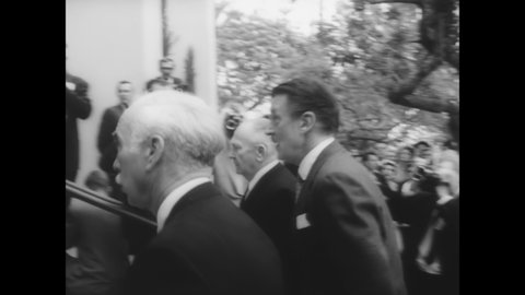 CIRCA 1961 - Edward G Robinson, Jimmy Durante, John Wayne, and others are photographed entering a church for Gary Cooper's funeral.