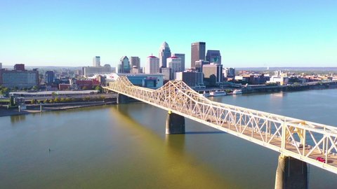 LOUISVILLE, KENTUCKY. - CIRCA 2020s - Aerial establishing shot of the downtown business district and Ohio River bridge in Louisville, Kentucky.