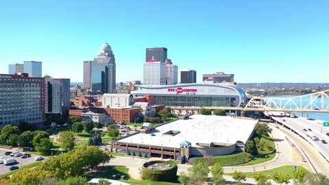 LOUISVILLE, KENTUCKY. - CIRCA 2020s - Aerial establishing shot of the downtown business district, KFC center, and Ohio River bridge.