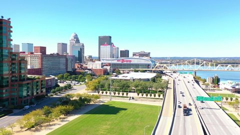 LOUISVILLE, KENTUCKY. - CIRCA 2020s - Aerial establishing shot of the downtown business district and Ohio River bridge in Louisville, Kentucky.