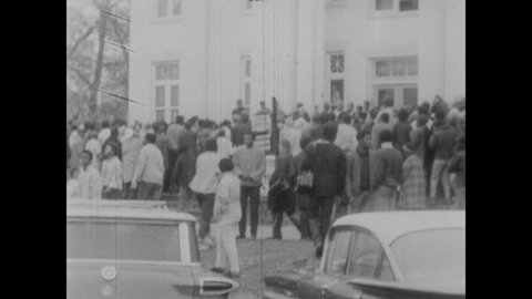 CIRCA 1968 - African-American protestors for the Poor People's Campaign sing outside a church.