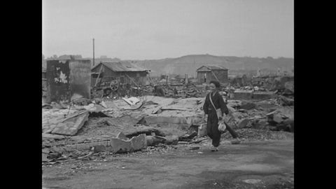 CIRCA 1945 - Japanese civilians walk, ride streetcars, and ride bicycles through the wreckage of their war-torn city.