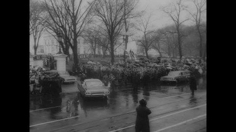 CIRCA 1962 - Huge crowds line Pennsylvania Avenue in Washington DC to catch a glimpse of John Glenn as his motorcade passes by.