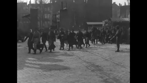 CIRCA 1945 - German POWs are marched onto an LCVP in Mainz, Germany.