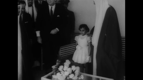 CIRCA 1962 - JFK visits King Saud at his convalescent home in Palm Beach, Florida, and young Princess Delal gives him carnations.