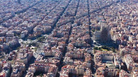 10.04.2019 - Barcelona Spain. City center aerial video footage from above. Eixample square blocks and Sagrada Familia and Avinguda Diagonal