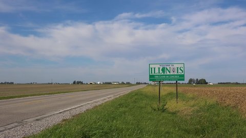 ILLINOIS - CIRCA 2020s - Sign along an abandoned rural road through the countryside indicates the Illinois state line.