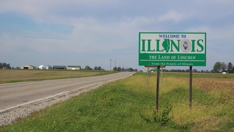 ILLINOIS - CIRCA 2020s - Sign along an abandoned rural road through the countryside indicates the Illinois state line.