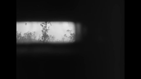 CIRCA 1945 - The periscope view from inside a tank shows a flame-throwing tank in action on the Ryukyu Islands.