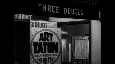 CIRCA 1940s - Signs advertise that the jazz pianist Art Tatum will be playing at the Three Deuces nightclub.