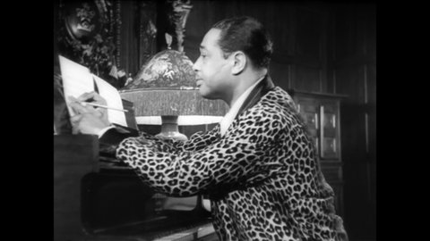 CIRCA 1940s - Duke Ellington writes a jazz song for the piano, playing a few notes at a time before writing them down.