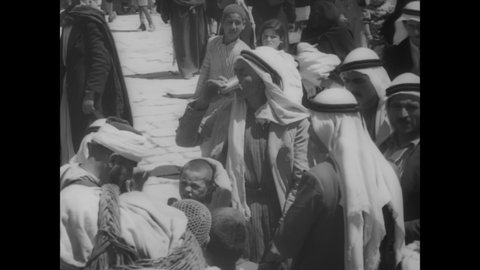 CIRCA 1930s - Food is sold at a busy Middle Eastern marketplace.