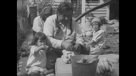 CIRCA 1920s - Native American farmers present their vegetables at a county fair.