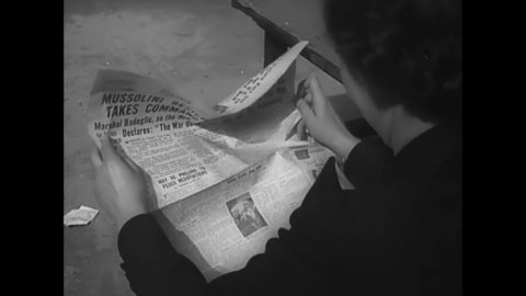 CIRCA 1943 - British civilians read headlines about Mussolini's resgination.