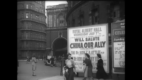 CIRCA 1943 - A billboard advertises a salute to China at London's Royal Albert Hall, with Clement Attlee and Anthony Eden in attendance.
