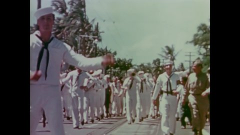 CIRCA 1945 - US Navy sailors and a US Navy band march in a V-J Day celebration in Hawaii.